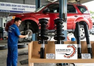 Kỹ thuật viên kiểm tra giảm xóc Ford Escape bằng máy chuyên dụng tại garage, xe được nâng cầu trong quá trình chẩn đoán.